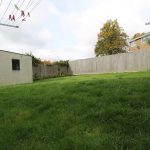 Spacious garden with clothesline and shed
