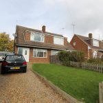 Detached house with driveway and parked car in front