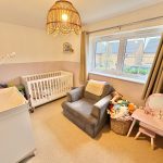 Cosy nursery with cot and toys by window