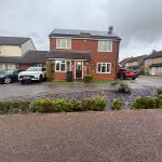 Brick house with cars in suburban street