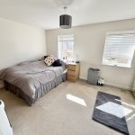 Bright bedroom with double bed and windows