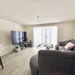 Modern living room with TV and sofa.