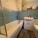 Modern bathroom with bathtub and wooden flooring